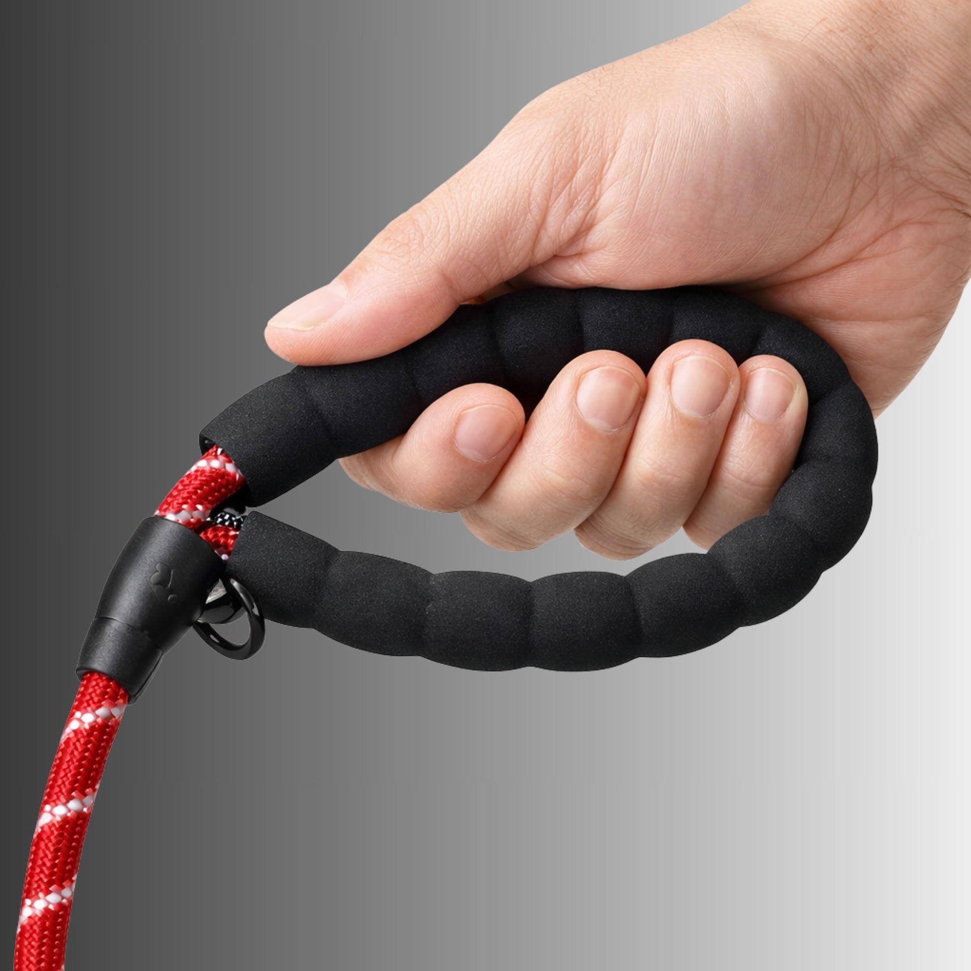 Hand holding padded handle of Spannerlife dog lead showing comfortable grip